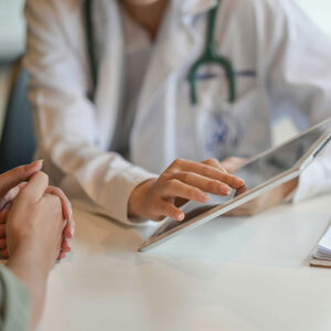 Doctor having a discussion with a patient going over information on a tablet