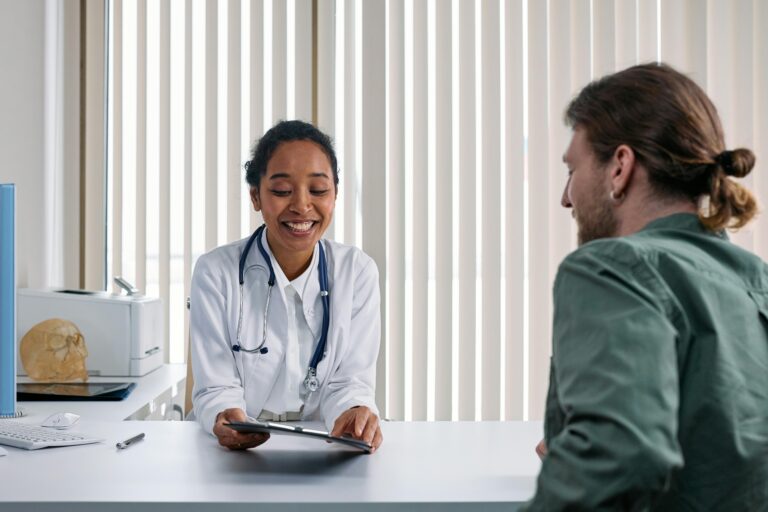 Female Social Services doctor reviewing charts with a man at Northern Maine Medical Center